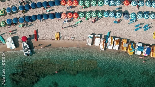 4k 25fps footage of Grotticelle beach near Capo Vaticano in the Calabria region. You notice the crystal clear Caribbean sea, the bathers and the colored umbrellas photo