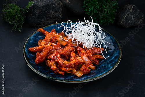 Pork with sweet peppers, onions and sesame seeds in honey and tomato sauce.