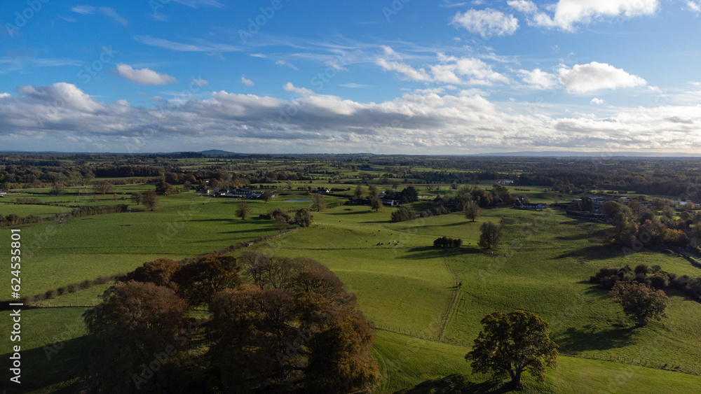 Fototapete mit Aerial view on green fields and meadows. Stunning aerial shot over lush green fields and meadows . #624535801