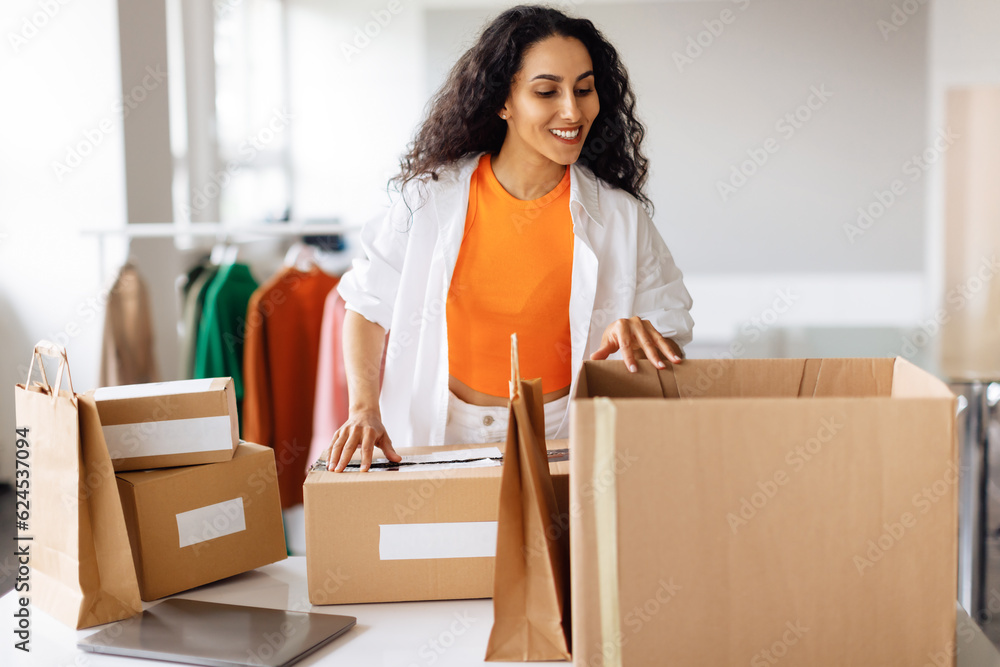 Lady Preparing Boxes For Shipping, Managing Clothing Orders At Showroom Lady Preparing Boxes For Shipping, Managing Clothing Orders At Showroom