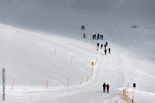People walking on Dachstein Glacier. Dachstein mountain station of the Schladming-Dachstein cable car in Austria, Europe.  photo