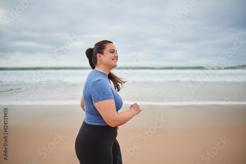 Wallpaper Mural Motivated body positive sports woman jogging at the sandy sea beach Torontodigital.ca