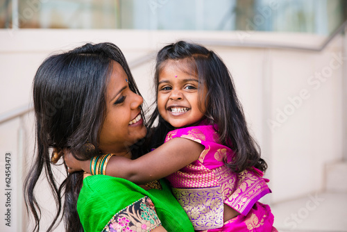 Photography beautiful indian family mom mother with daughter girl hugging and smiling with a