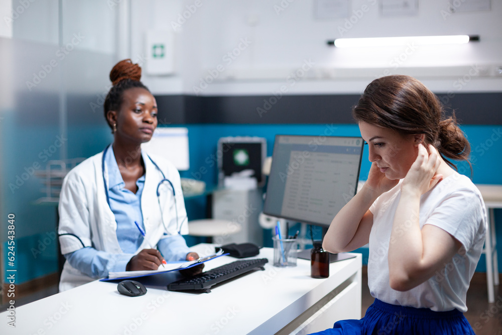 Fototapeta premium General practitioner doctor consulting patient with sore, hurt, aching painful neck nape symptoms. Healthcare specialist medical appointment check-up in modern clinic office