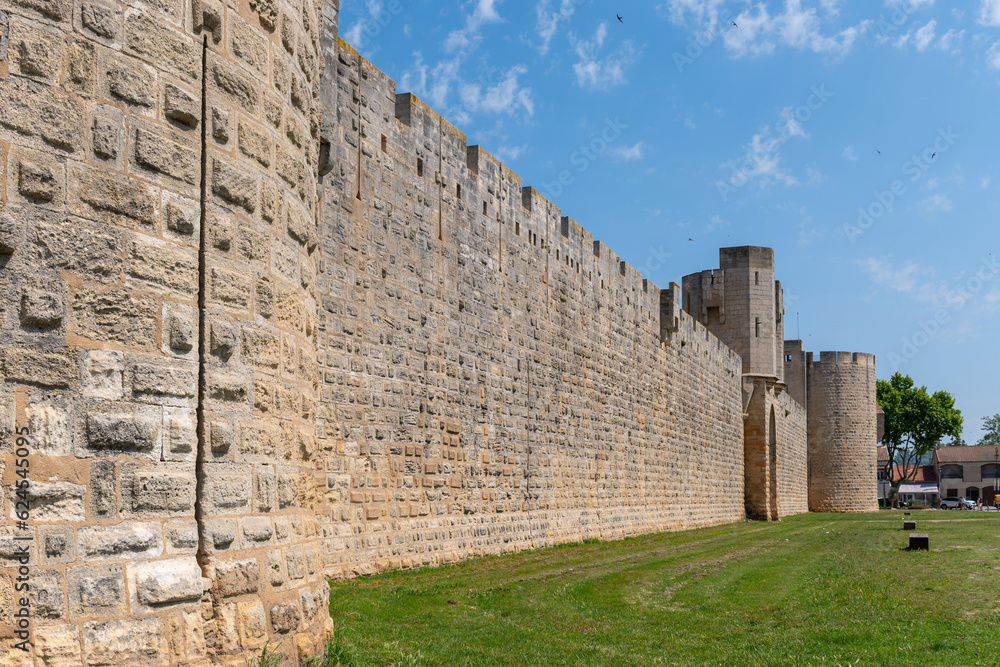 View on old streets, fort walls and houses in ancient french town Aigues-Mortes, touristic destination with square fortress, Gard, France