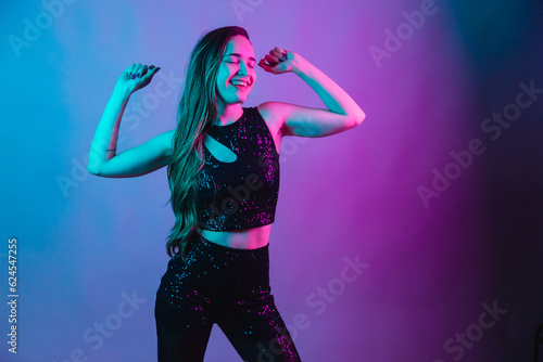Model on blue and pink neon background posing for photo. dancing.