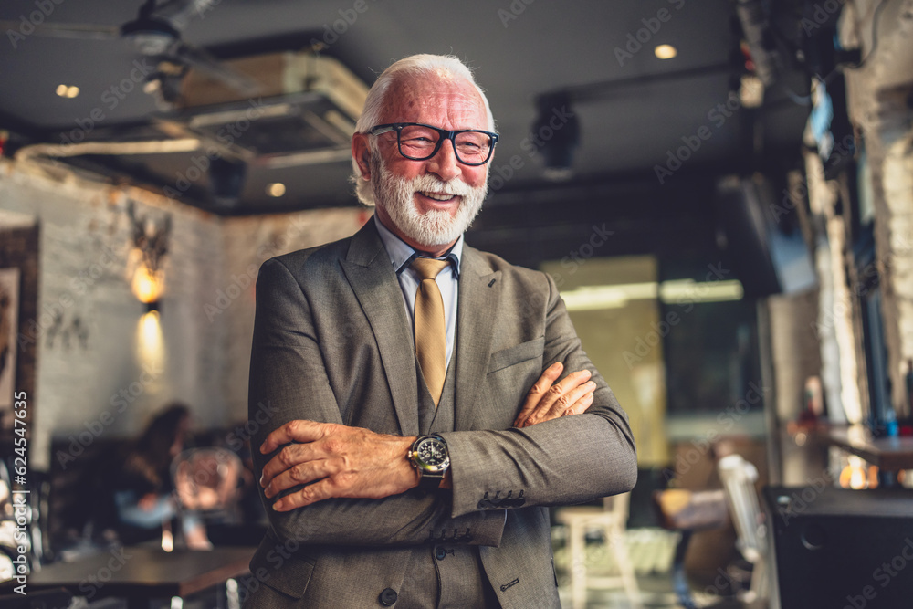Portrait of one senior man businessman stand in cafe or restaurant Portrait of one senior man businessman stand in cafe or restaurant