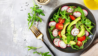 Diet menu. Healthy salad of fresh vegetables - tomatoes, avocado, arugula, radish and seeds on a bowl. Vegan food. Flat lay. Banner. Top view