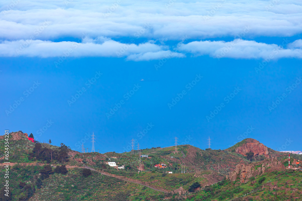 Mountain landscape with white clouds and blue sky over the ocean , Gran Canaria , Spain