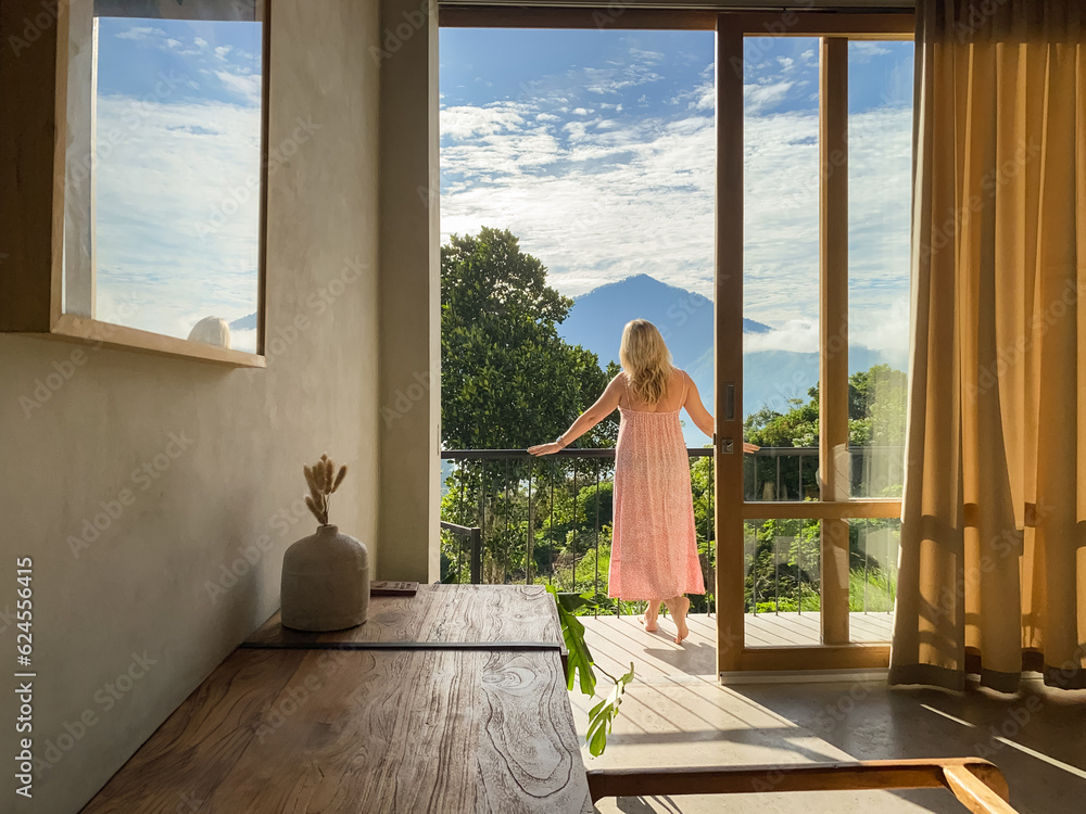 A middle-aged woman  looks at the jungle and mountains