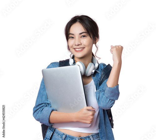 Portrait of smiling young Asian college student with laptop and backpack isolated over pink background.Cheer up success celebration concept