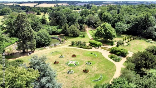 Flying over treetops towards Hylands House gardens 

Hylands Park Estate, located in Chelmsford, Essex, is a stunning expanse of natural beauty and historical significance.  photo