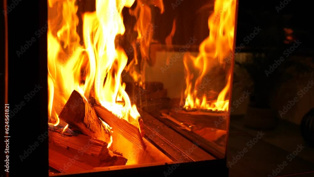 Flame and firewood in a glass fireplace.Sparks and flame close-up. Warm relaxing fireplace. Fireplace in the interior.Fire up the fireplace. slow motion.Warm cozy home atmosphere. 4k footage Flame and firewood in a glass fireplace.Sparks and flame close-up. Warm relaxing fireplace. Fireplace in the interior.Fire up the fireplace. slow motion.Warm cozy home atmosphere. 4k footage
