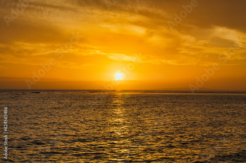 Fiery golden sky as sun sets on Maui.