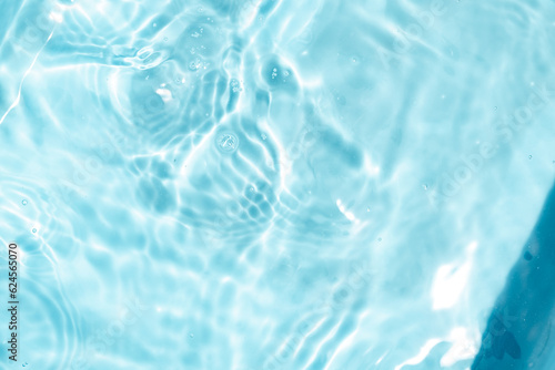 Closeup Transparent blue clear water surface texture with ripples. Abstract​ of​ surface​ blue​ splashes and bubbles​ water waves reflected​ with​ sunlight​ for