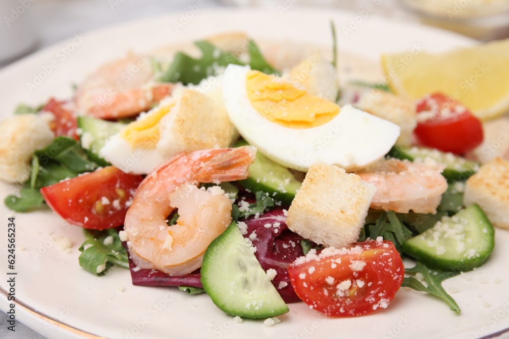 Delicious Caesar salad with shrimps on plate, closeup Delicious Caesar salad with shrimps on plate, closeup