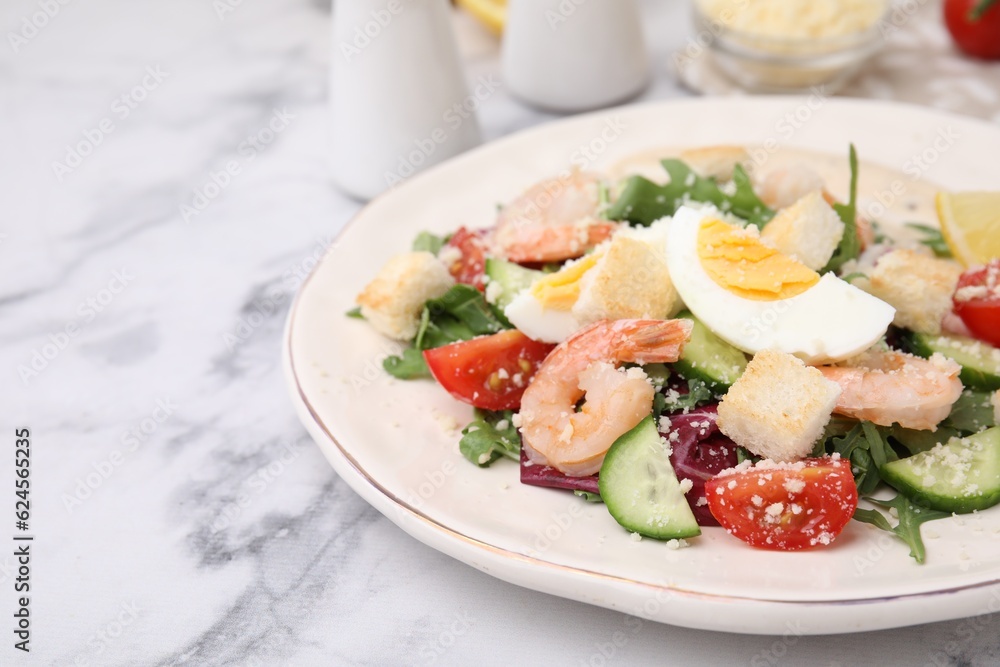 Delicious Caesar salad with shrimps on white marble table, closeup. Space for text Delicious Caesar salad with shrimps on white marble table, closeup. Space for text