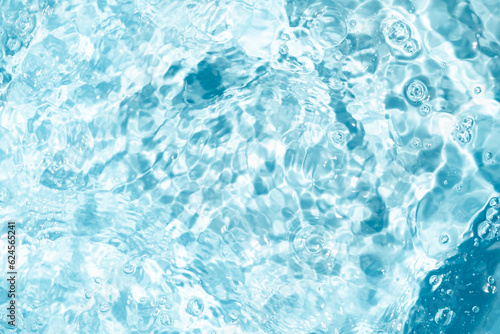 Closeup Transparent blue clear water surface texture with ripples. Abstract​ of​ surface​ blue​ splashes and bubbles​ water waves reflected​ with​ sunlight​ for