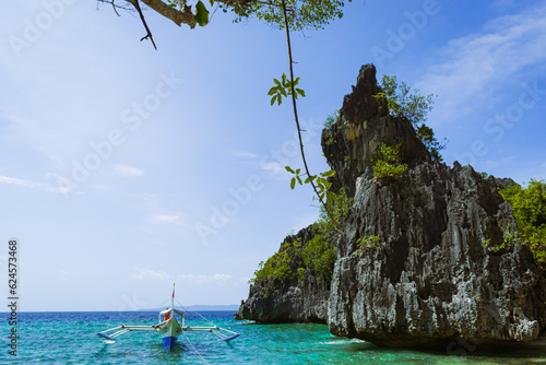 Tropical island rocks on a blue sea. Calatrava, Romblon, Philippines photo