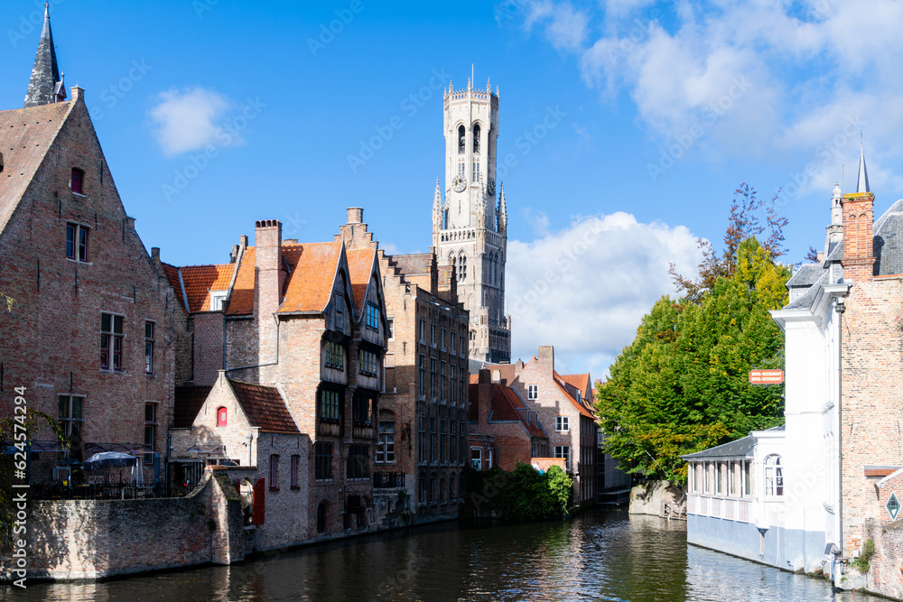 Characteristic view of the canals of Bruges. In the background, the belfry (belfort) stands out. Belgium Characteristic view of the canals of Bruges. In the background, the belfry (belfort) stands out. Belgium
