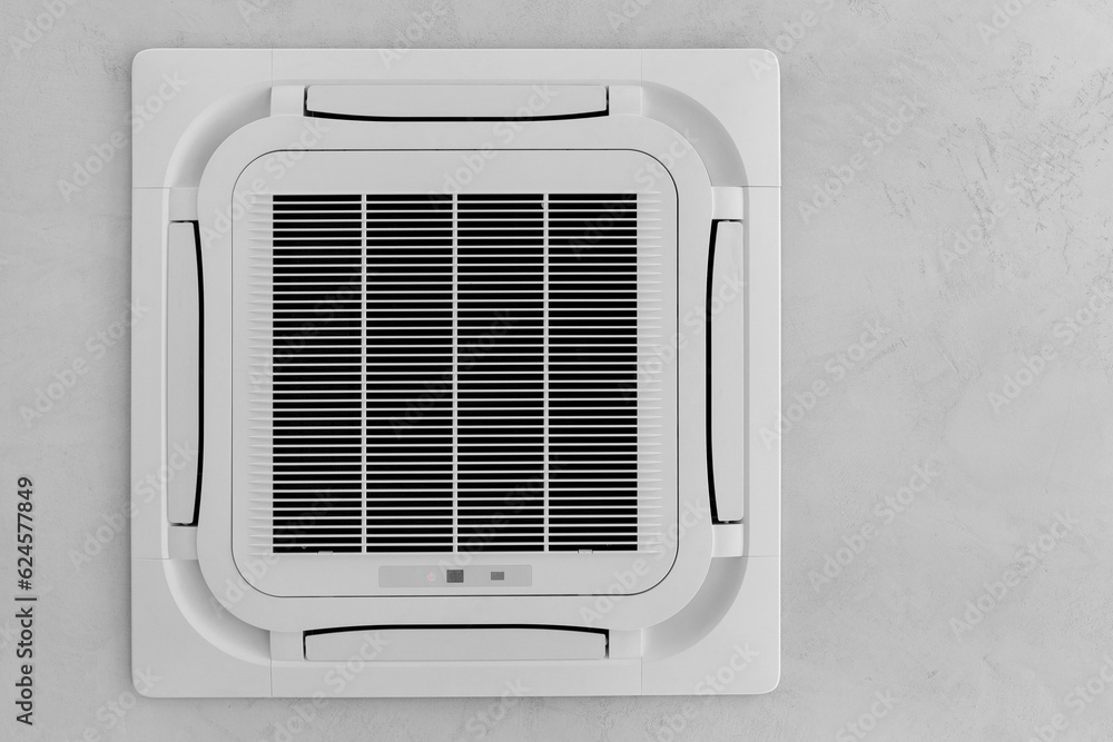 Obraz premium Ceiling white air conditioner built into the ceiling.