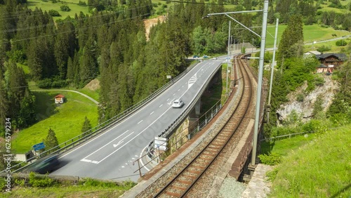 Time Lapse, cars traffic over bridge in the Swiss Alps. Solis Viaduct. Canton of Graubünden, Switzerland. photo