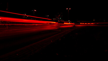 Papier peint photo Autoroute de nuit Bandes rouges route nocturne défocalisée  © anna.stasiia