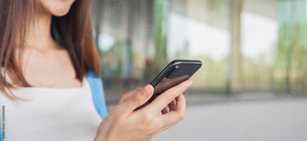 woman using smartphone in public areas, During leisure time. The concept of using the phone is essential in everyday life. woman using smartphone in public areas, During leisure time. The concept of using the phone is essential in everyday life.