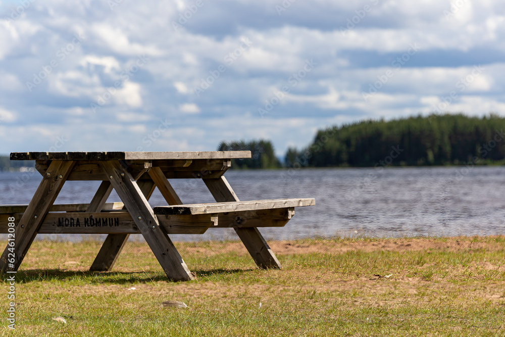 Mora, Sweden A picnic table on the shore of Lake Siljan. Sign says Mora Municipality in Swedish Mora, Sweden A picnic table on the shore of Lake Siljan. Sign says Mora Municipality in Swedish