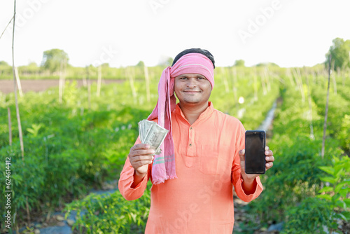 Happy Indian farmer, farmer holding indian rupees in hands, smart farming