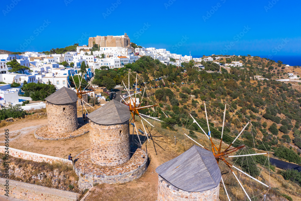 The three windmills of Chora and iconic Monastery of Saint John the Theologian in chora of Patmos island, Dodecanese, Greece