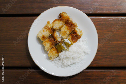 Kue putu, a traditional Indonesian snack made from rice flour filled with palm sugar and grated coconut as topping photo
