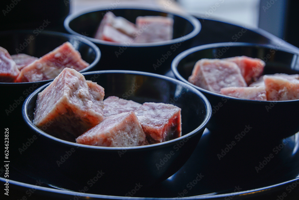 Cubes of raw beef meat in bowl Cubes of raw beef meat in bowl