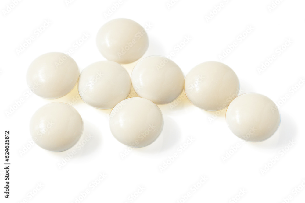 Top view of Many Circle-shaped white pills isolated on a white background. Top view of Many Circle-shaped white pills isolated on a white background.