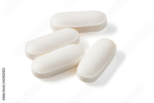 Top view of Many long-shaped white pills isolated on a white background.