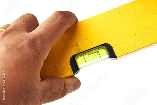 Hand Holding old Water Level Gauge Ruler (Spirit Level) isolated on white background. Spirit Level is a device used for measuring the level of inclination horizontal and vertical.