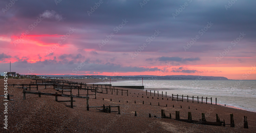 Moody sunrise from the coast at Pevensey bay east Sussex south east England UK