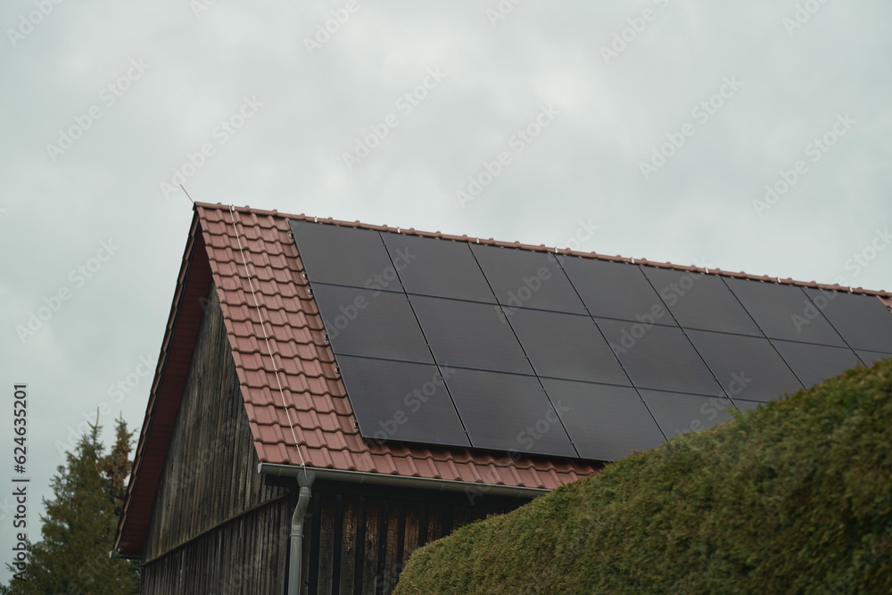 Solar panels on a roof. Beautiful, large modern house and solar energy. Harnessing Clean Energy. Solar Panels on a Modern House Solar panels on a roof. Beautiful, large modern house and solar energy. Harnessing Clean Energy. Solar Panels on a Modern House