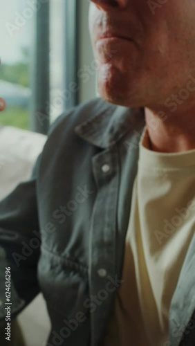 FatherA man and two boys are sitting on the couch and eating snacks while watching TV at home. They enjoy scoring a goal while watching football and sons eating snacks sitting on the couch photo