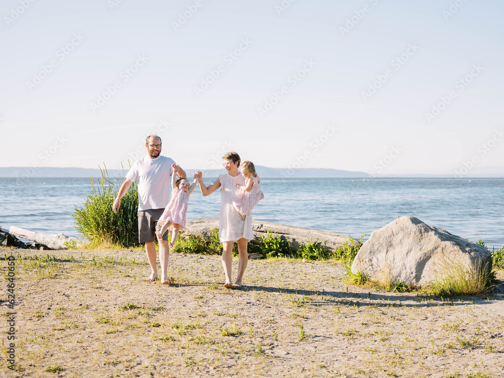 family of four enjoying a cliffside moment, overlooking the ocean family of four enjoying a cliffside moment, overlooking the ocean