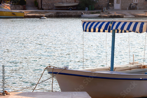 Small fishing boat and picturesque skyline in Vela Luka, island Korcula, Croatia.