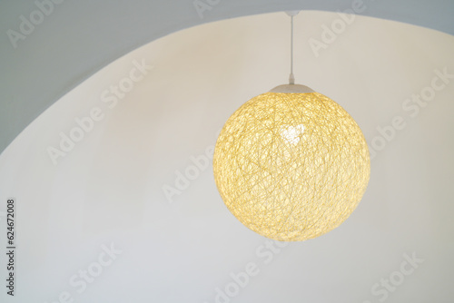 Round ceiling lamp made of thread on white background