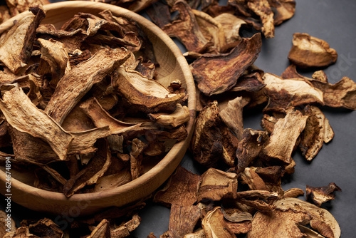 Photography Close-up of dried porcini mushroom slices on moving platform