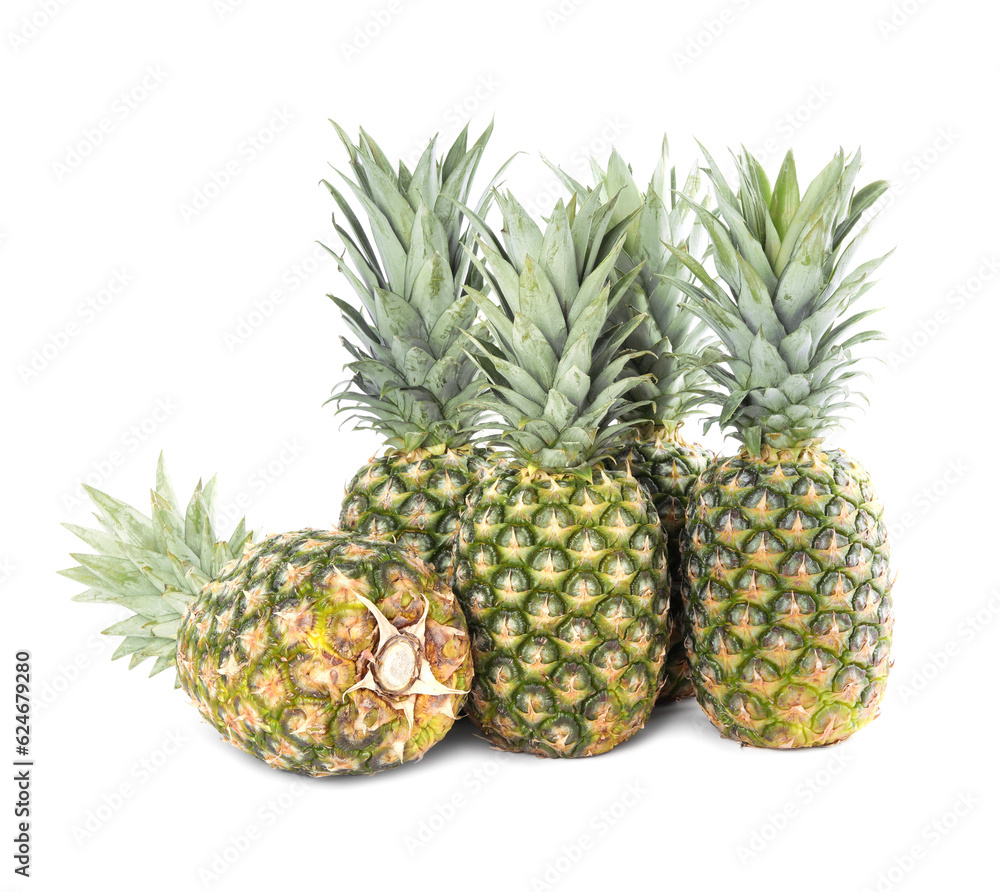Many delicious ripe pineapples on white background