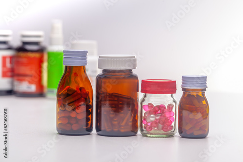 Unlabeled pill bottles lined up on a white background