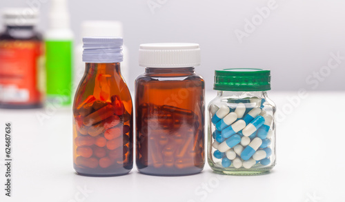 Unlabeled pill bottles lined up on a white background