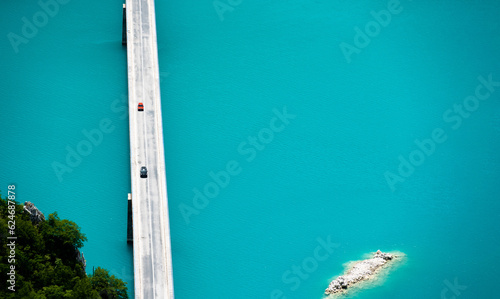 Scenic bridge over canyon lake Piva in Montenegro from above with beautiful color os water. Aerial drone view on nature in national park photo