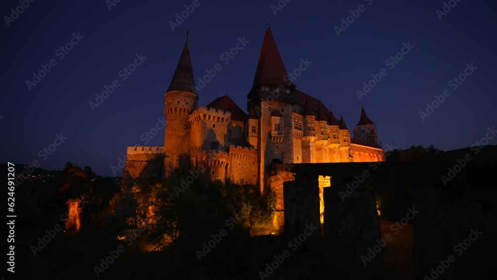 Corvin (Hunyad) Castle in Hunedoara during the night. 4K wide angle video pan camera movement with this amazing medieval castle landmark in Romania. Corvin (Hunyad) Castle in Hunedoara during the night. 4K wide angle video pan camera movement with this amazing medieval castle landmark in Romania.