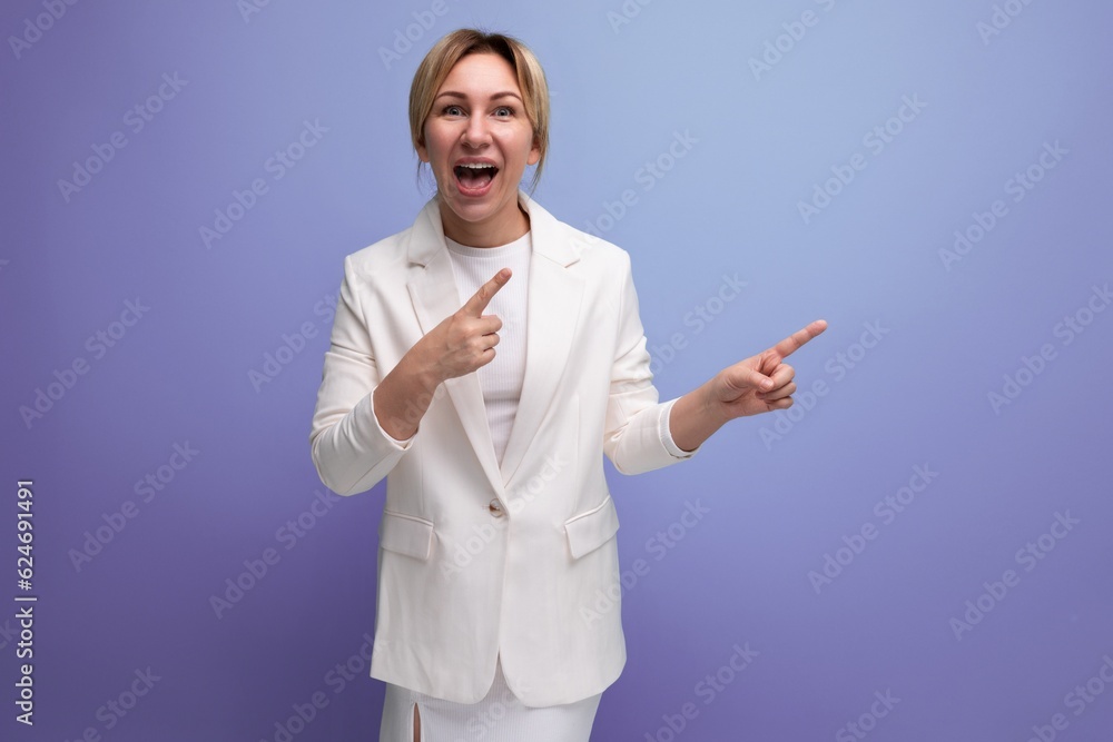 emotional young blond employer woman in a white elegant jacket and skirt screaming pointing her finger to the side emotional young blond employer woman in a white elegant jacket and skirt screaming pointing her finger to the side
