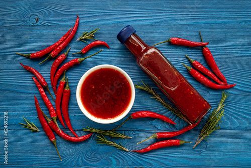 Red chili sauce ketchup or tabasco with ripe hot pepper